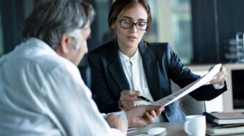 Femme Montre Un Document à Un Homme Dans Un Espace De Travail